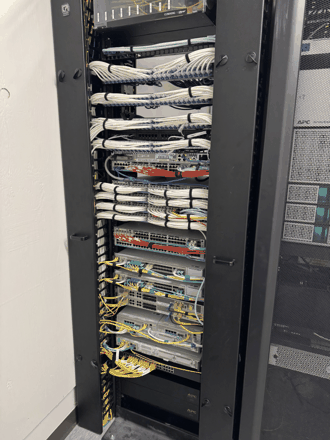 Floor rack, patch panels and switches, color-coded.