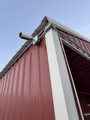 Bullet camera under a metal eave.